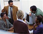 Business People Gathered around Computer, Talking