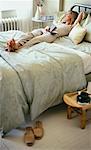 Woman Lying on Bed, Holding Book