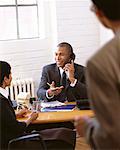 Businessman at Desk, Using Telephone in Meeting