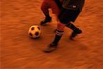 Close-Up of Soccer Players Kicking Ball