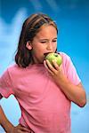 Girl Eating Apple Outdoors