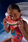 Portrait of Girl in Swimwear Eating Watermelon in Pool
