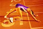 Woman at Starting Position on Running Track