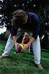 Father and Son Playing Football Outdoors