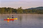 Man and Woman Kayaking Belgrade Lakes, Maine, USA