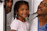 Portrait of Girl Having Height Measured by Mature Male Doctor