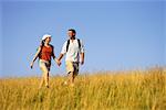 Couple Hiking through Tall Grass Belgrade Lakes, Maine, USA