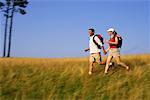 Couple Hiking through Tall Grass Belgrade Lakes, Maine, USA