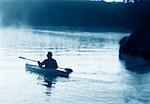 Back View of Man Kayaking