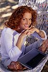 Portrait of Woman Sitting in Hammock with Laptop Computer