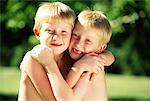 Portrait of Twin Boys Embracing Outdoors