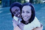 Portrait of Mother and Daughter Embracing Outdoors