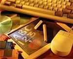 Blackboard and Chalk with Computer Keyboard, Mouse, Compact Discs and Cassettes