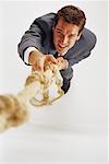 Overhead View of Businessman Climbing Rope