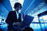 Businesswoman Using Laptop in Terminal