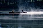 Couple Canoeing on Lake with Mist Haliburton, Ontario, Canada