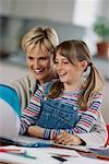 Mother and Daughter Using Laptop Computer, Smiling