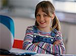Portrait of Girl at Laptop Computer with Arms Crossed