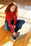 Portrait of Woman Sitting on Floor with Laptop Computer