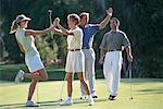 Group of People on Golf Course Celebrating