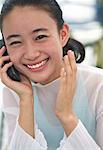 Portrait of Young Woman Using Cell Phone, Laughing