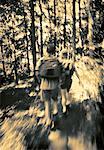 Back View of Couple Hiking Through Forest, Belgrade Lakes Maine, USA