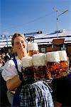 Portrait of Oktoberfest Girl Holding Mugs of Beer Munich, Germany