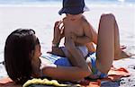 Mother and Baby in Swimwear on Beach