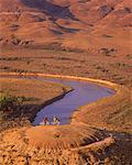 Couple on Mountain Bikes near River, Milk River Valley, Alberta, Canada