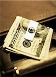 Close-Up of American Currency With Money Clip on Briefcase