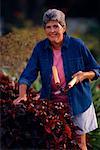 Portrait of Mature Woman Holding Hedge Clippers in Garden