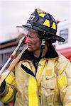 Male Firefighter Holding Axe Outdoors