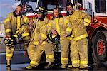 Group Portrait of Male Firefighters Leaning on Fire Engine