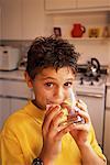 Portrait of Boy Drinking Glass Of Water in Kitchen