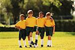 Group Portrait of Boys and Girls In Soccer Uniforms Outdoors