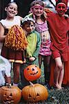 Group Portrait of Children in Halloween Costumes Outdoors