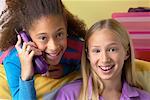 Portrait of Two Girls Using Cordless Phone in Bedroom