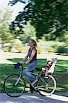 Mother Riding Bike in Park with Child