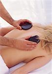 Woman Having Warming Rock Therapy On Back