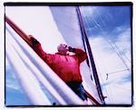 Mature Man Using Cell Phone on Sailboat