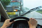 Driver's Perspective in Car on Road with Transport Truck in Rain