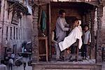 Barber Shaving Customer in Shop Under Portico Bhaktapur, Kathmandu, Nepal