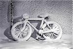 Snow Covered Bike Leaning on Snow Covered Fence in Winter