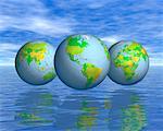 Trois Globes affichant les Continents du monde flottant au-dessus de l'eau aux reflets