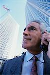 Mature Businessman Using Cell Phone Outdoors