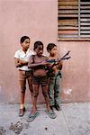 Portrait of Children Playing with Toy Guns Outdoors Havana, Cuba