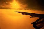 Airplane Wing and Clouds at Sunset