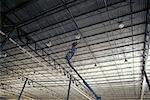Man on Crane in Warehouse, Iowa, USA