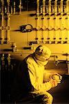 Worker Reading Gas Meter in Clean Room Environment