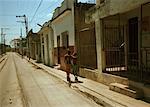 Back View of Two Boys Walking on Street Regla, Cuba
